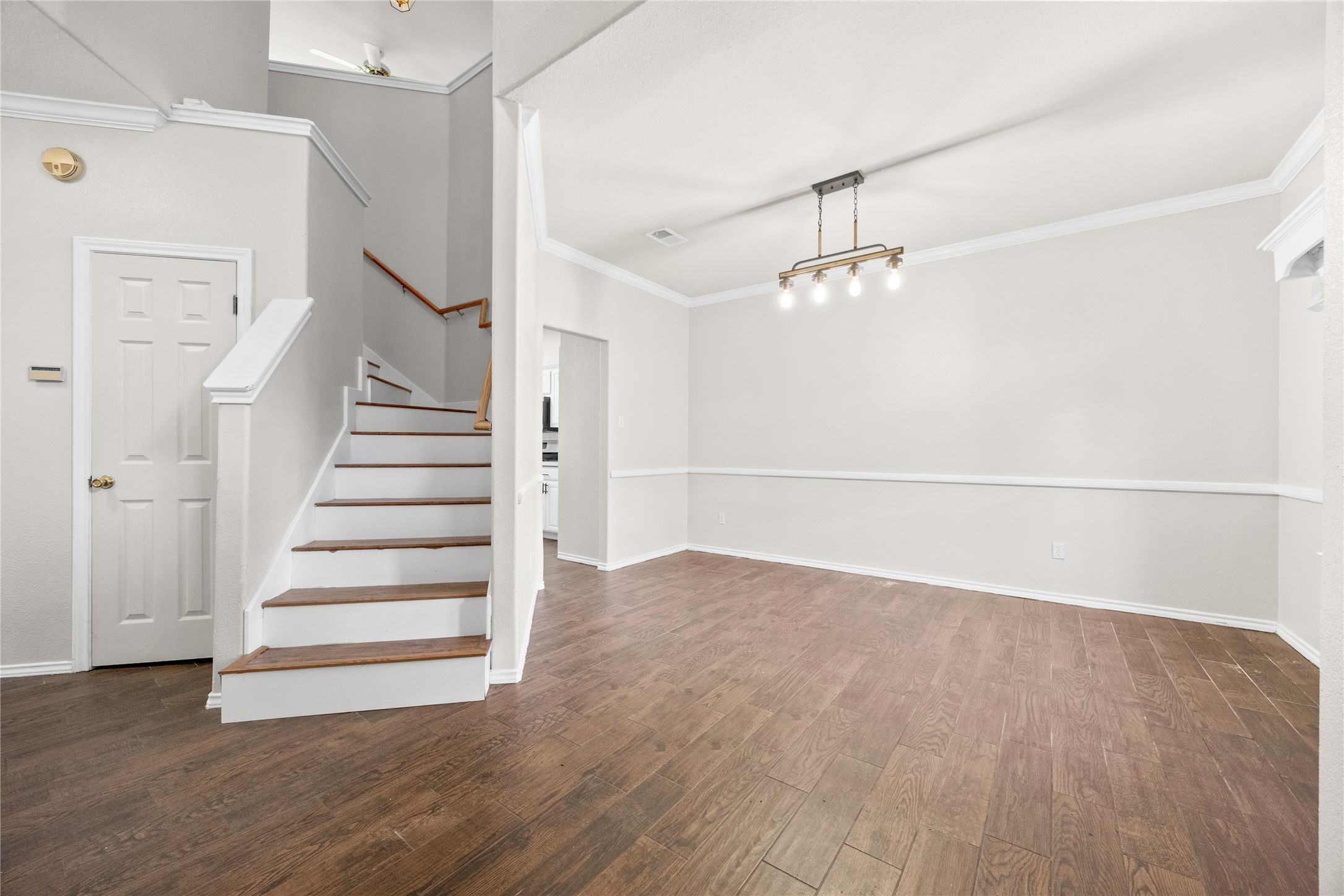 13217 Rochester Lane Austin, TX 78753 - Photo 16 of 30 Rich wood floors flow past the elegant staircase into a spacious dining area.