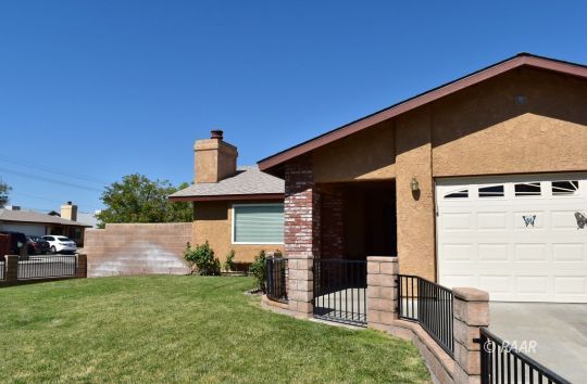 111 North American Street Ridgecrest, CA 93555 - Photo 1 of 10 a front view of a house with a yard