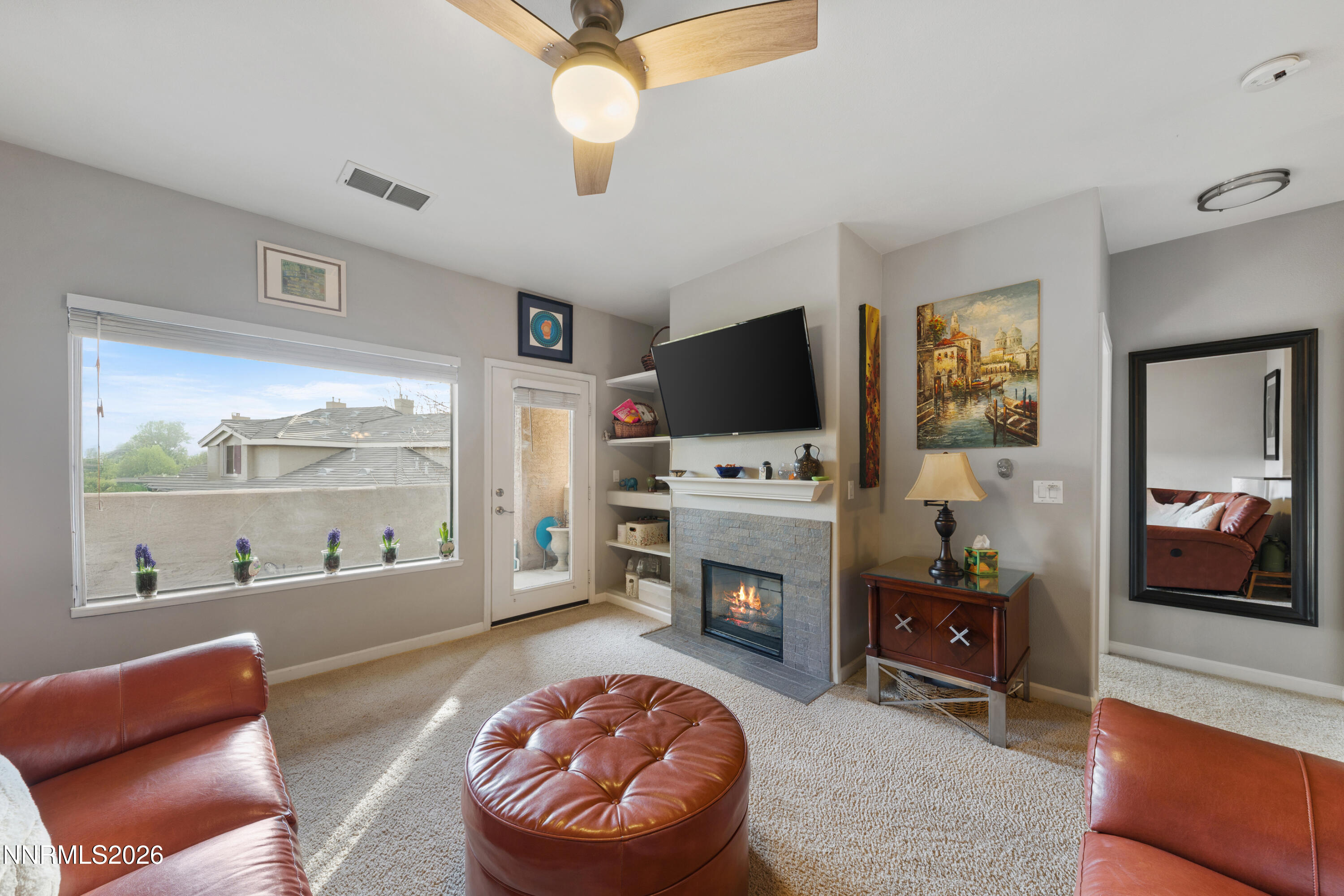 900 South Meadows Parkway, Unit 3222 Reno, NV 89521 - Photo 17 of 43 a living room with furniture a flat screen tv and a fireplace