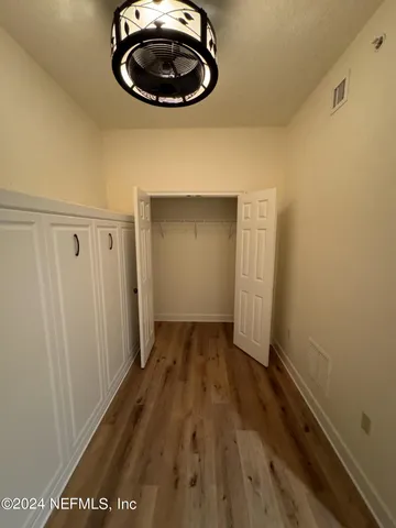 a view of a room with wooden floor