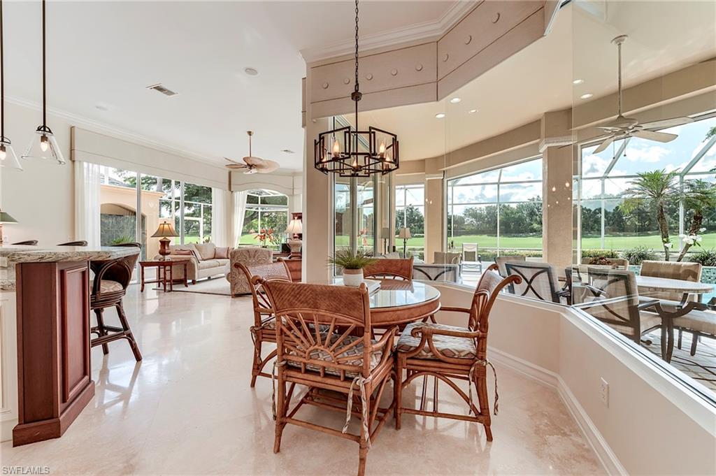 10200 Orchid Ridge Lane Estero, FL 34135 - Photo 11 of 50 a dining room with furniture a chandelier and fireplace