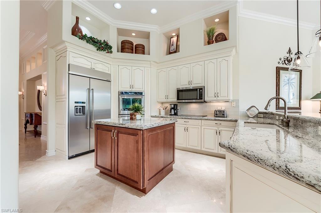 10200 Orchid Ridge Lane Estero, FL 34135 - Photo 14 of 50 a kitchen with stainless steel appliances granite countertop a refrigerator a stove and a sink