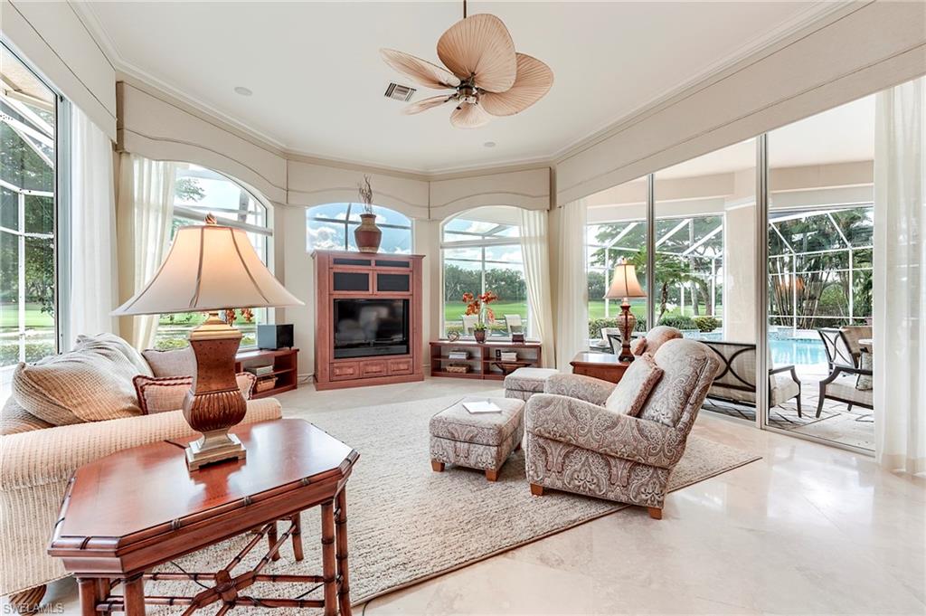 10200 Orchid Ridge Lane Estero, FL 34135 - Photo 17 of 50 a living room with furniture a flat screen tv and large windows
