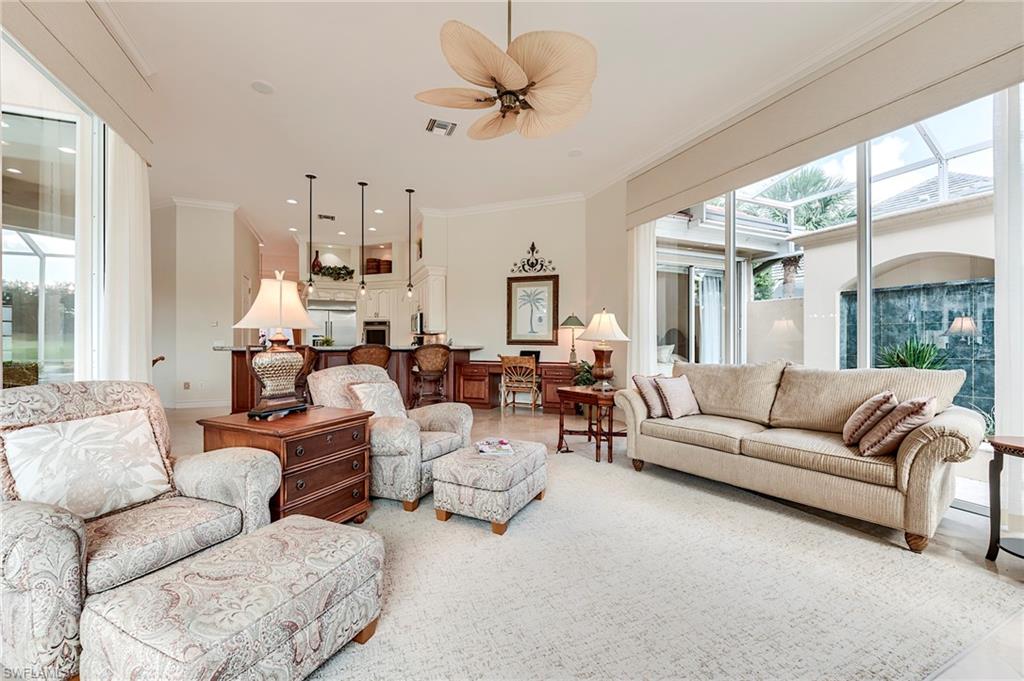 10200 Orchid Ridge Lane Estero, FL 34135 - Photo 18 of 50 a living room with furniture ceiling fan and a large window