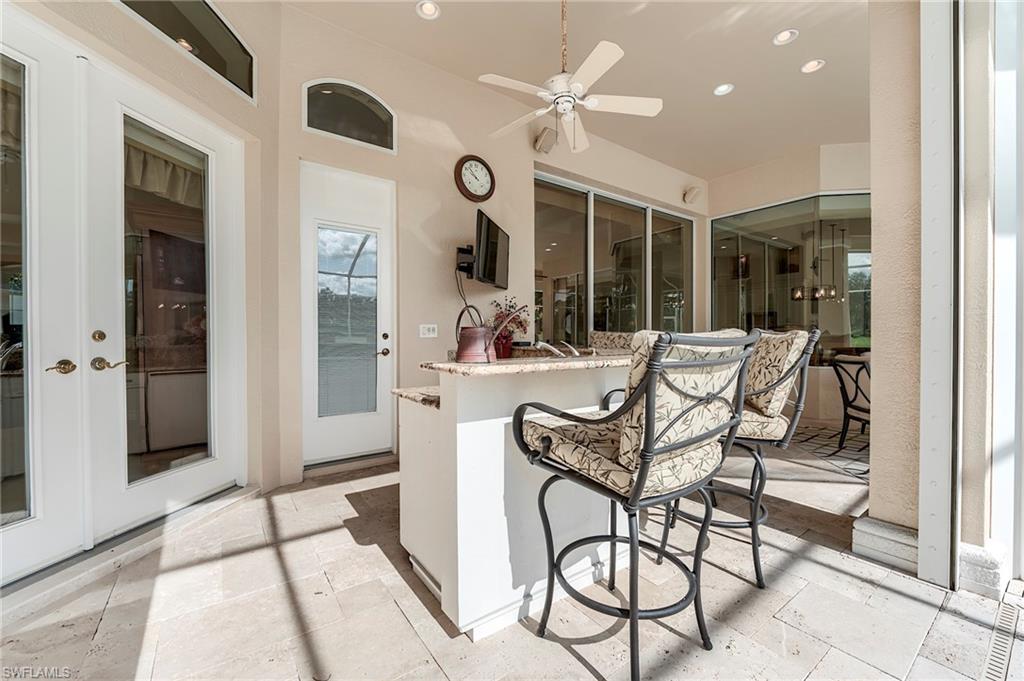 10200 Orchid Ridge Lane Estero, FL 34135 - Photo 30 of 50 a living room with furniture a large window and stainless steel appliances