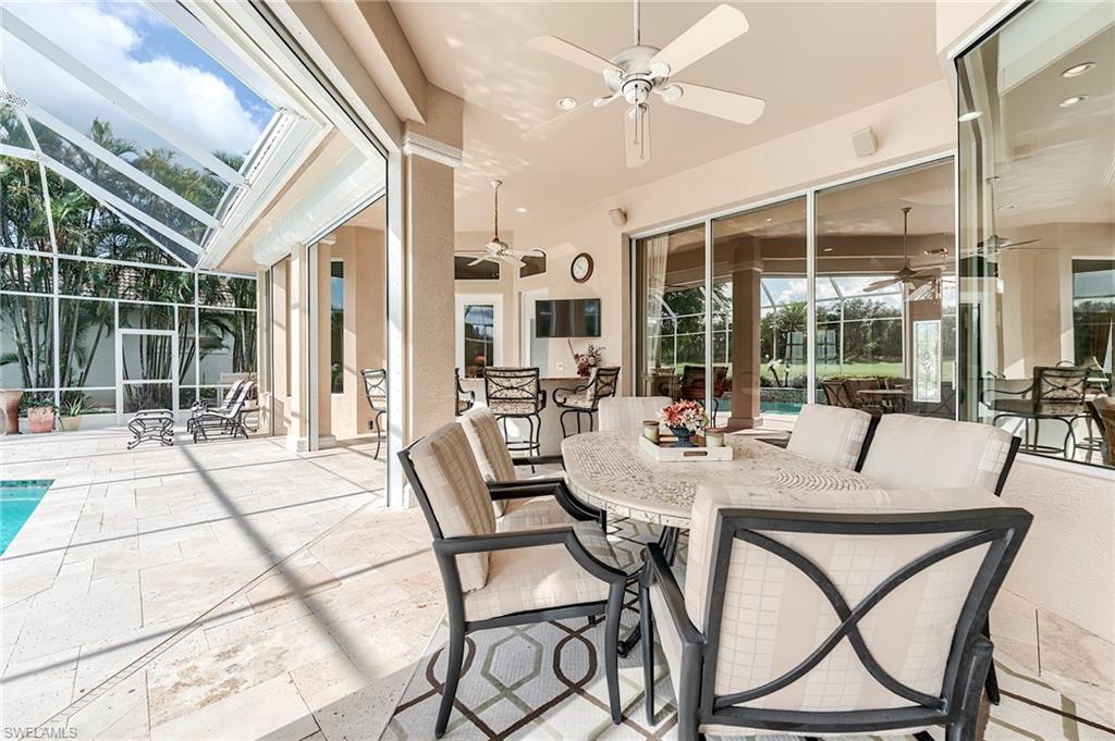 10200 Orchid Ridge Lane Estero, FL 34135 - Photo 31 of 50 a view of a dining room with furniture wooden floor and chandelier