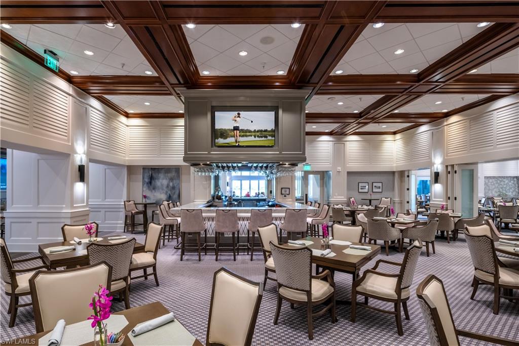 10200 Orchid Ridge Lane Estero, FL 34135 - Photo 41 of 50 a living room with lots of furniture and a chandelier