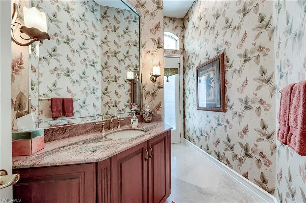 10200 Orchid Ridge Lane Estero, FL 34135 - Photo 10 of 50 a bathroom with a granite countertop sink and a mirror