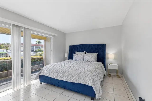 a bedroom with a bed and glass door