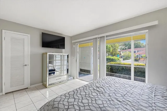 a bedroom with a bed and a television