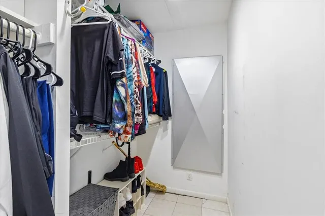 a view of walk in closet with clothes