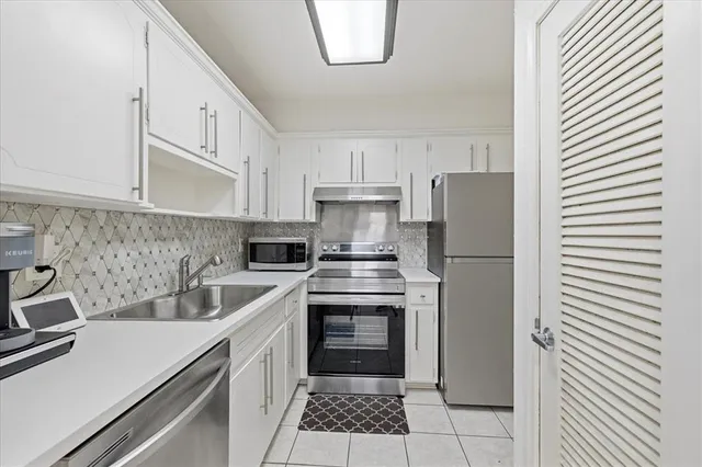 a kitchen with a white cabinets and white appliances