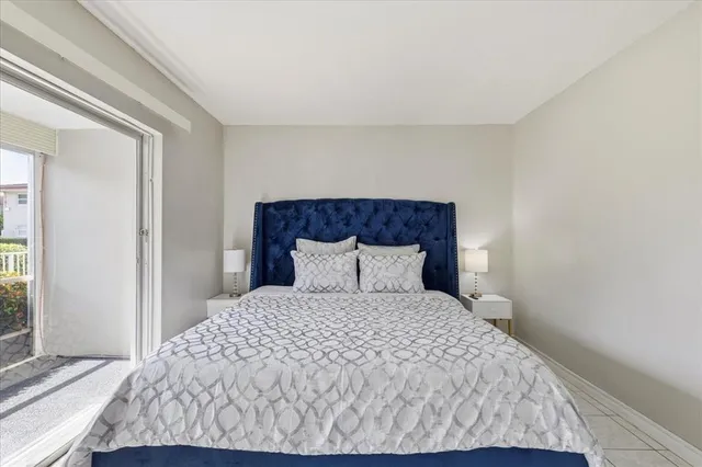 a large bed sitting in a bedroom next to a window