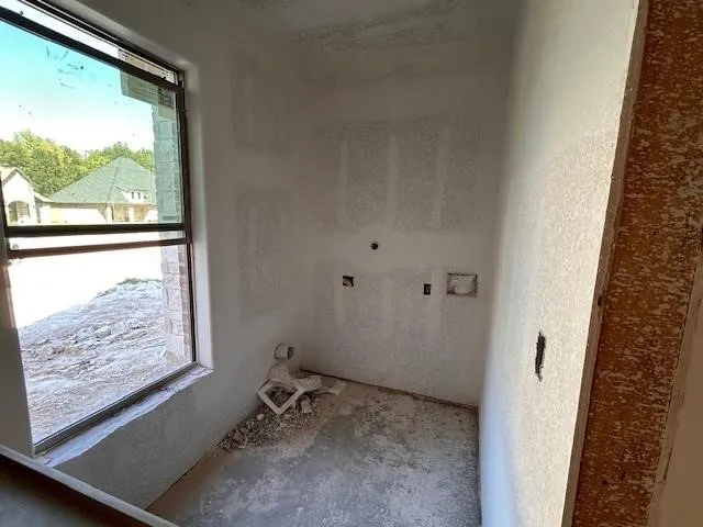 a view of a room with wooden floor and windows