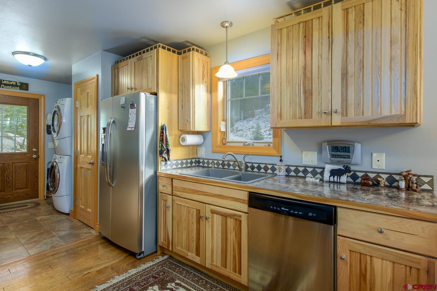 825-823 Main Street Pitkin, CO 81241 - Photo 11 of 42 a kitchen with stainless steel appliances granite countertop a refrigerator and a sink