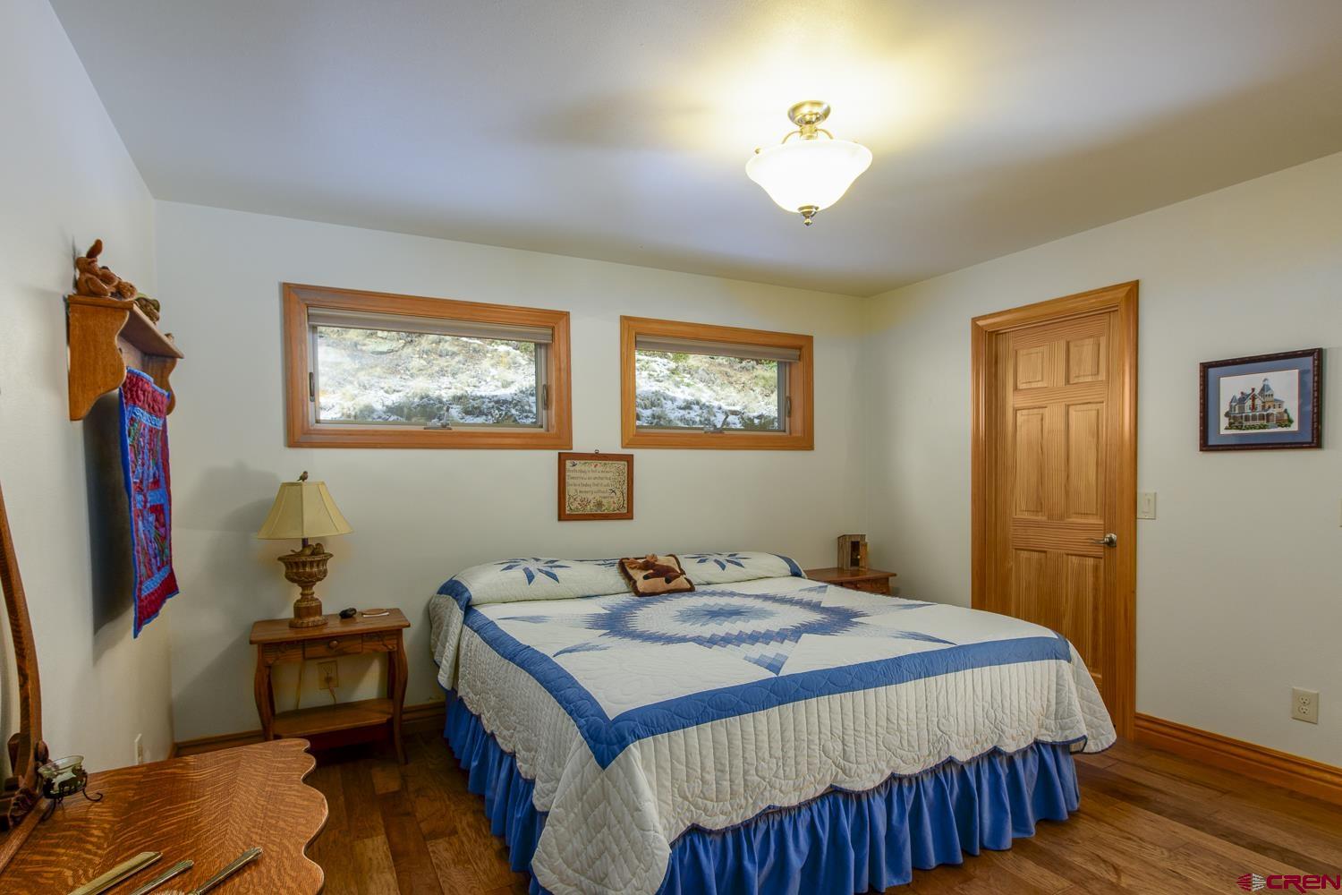 825-823 Main Street Pitkin, CO 81241 - Photo 15 of 42 a bedroom that has a bed and a dresser in it