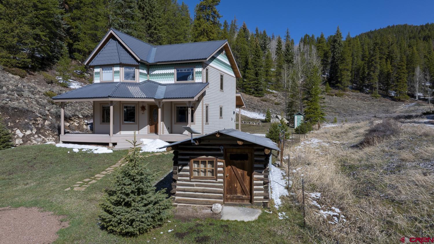 825-823 Main Street Pitkin, CO 81241 - Photo 2 of 42 a front view of a house with a yard garden and outdoor seating