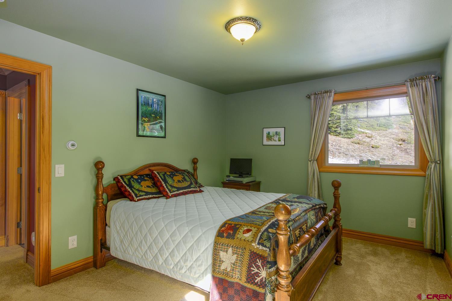 825-823 Main Street Pitkin, CO 81241 - Photo 25 of 42 a bedroom with a bed and a window