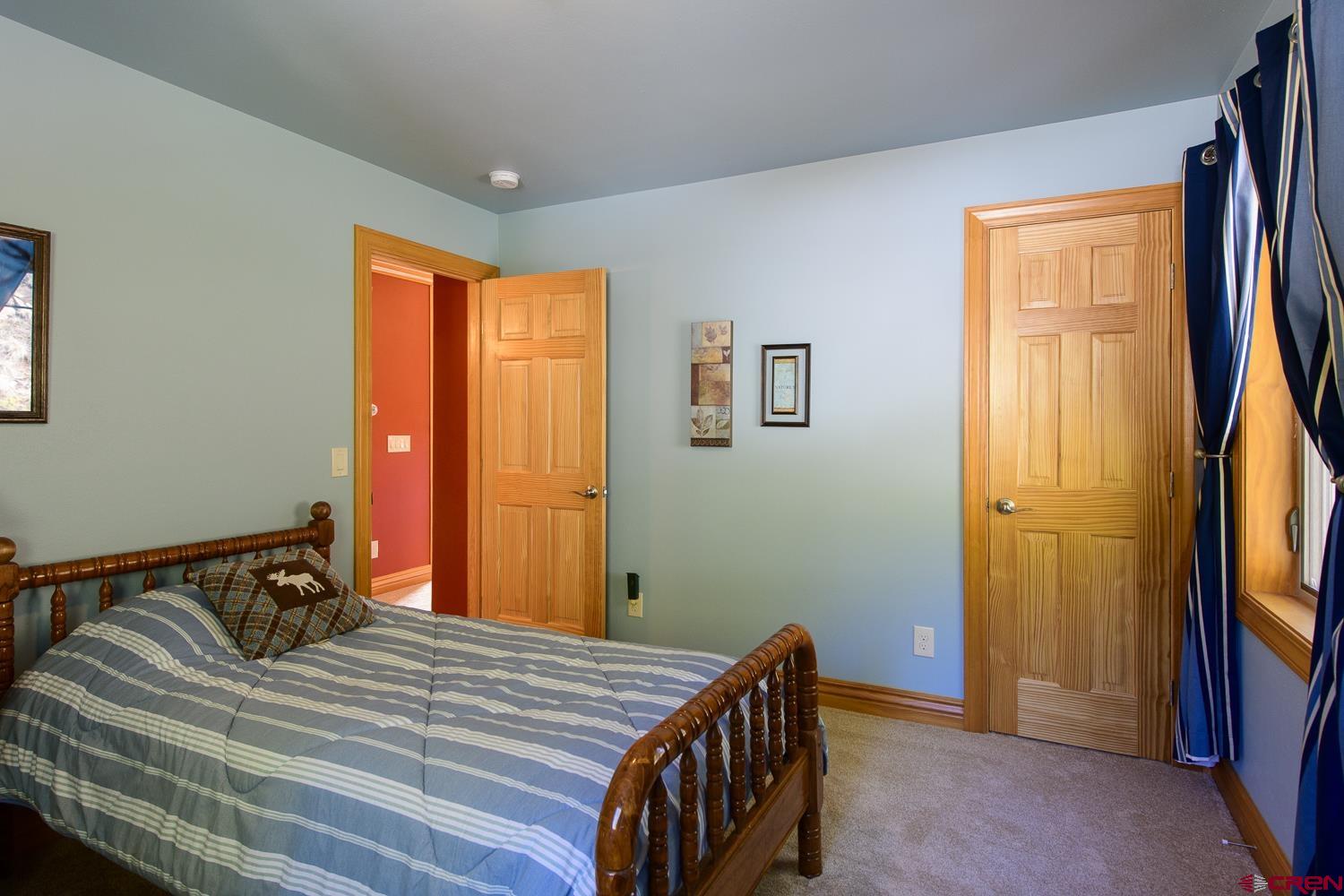 825-823 Main Street Pitkin, CO 81241 - Photo 29 of 42 a bedroom with a bed and wooden floor