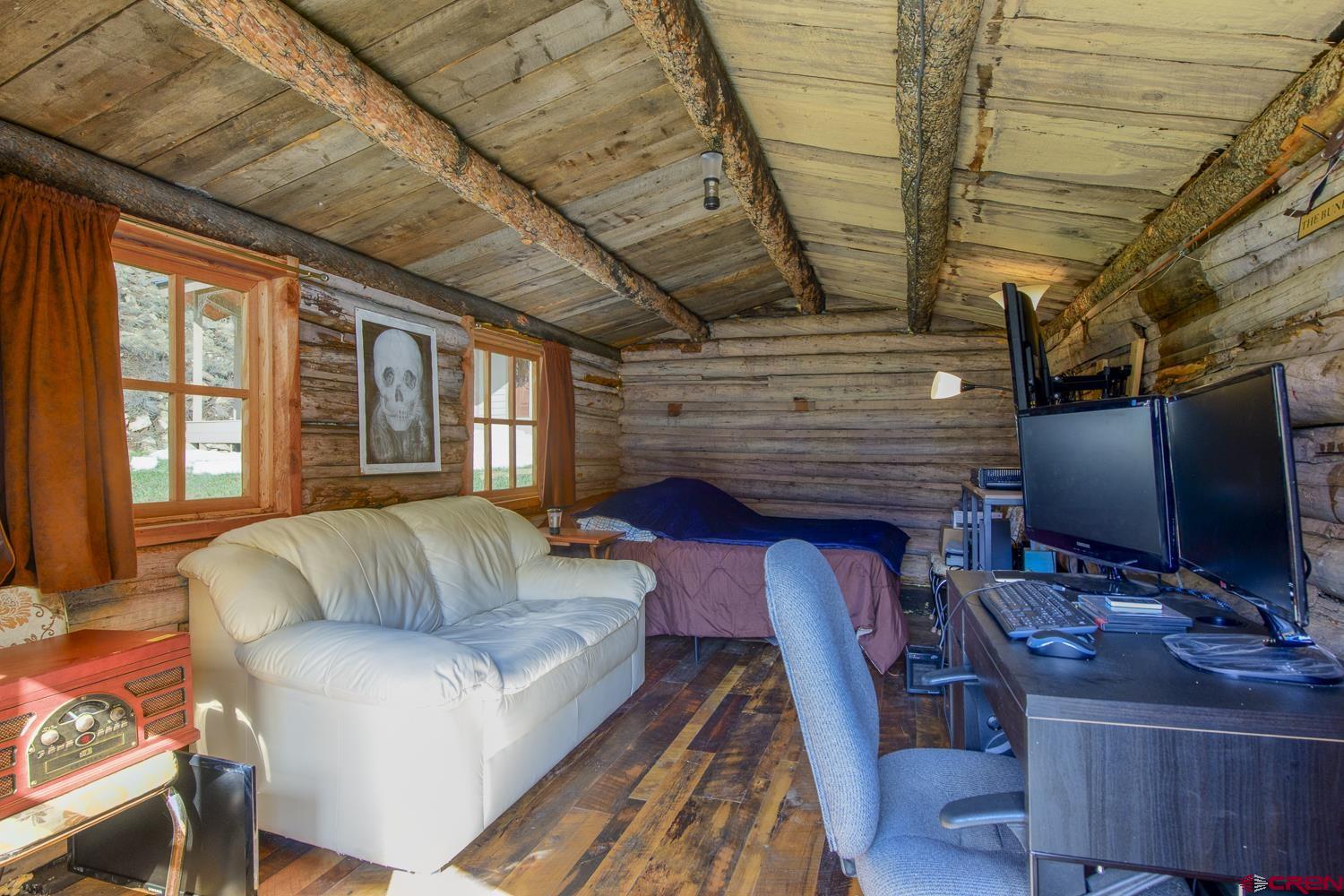 825-823 Main Street Pitkin, CO 81241 - Photo 39 of 42 a living room with furniture a flat screen tv and a fireplace