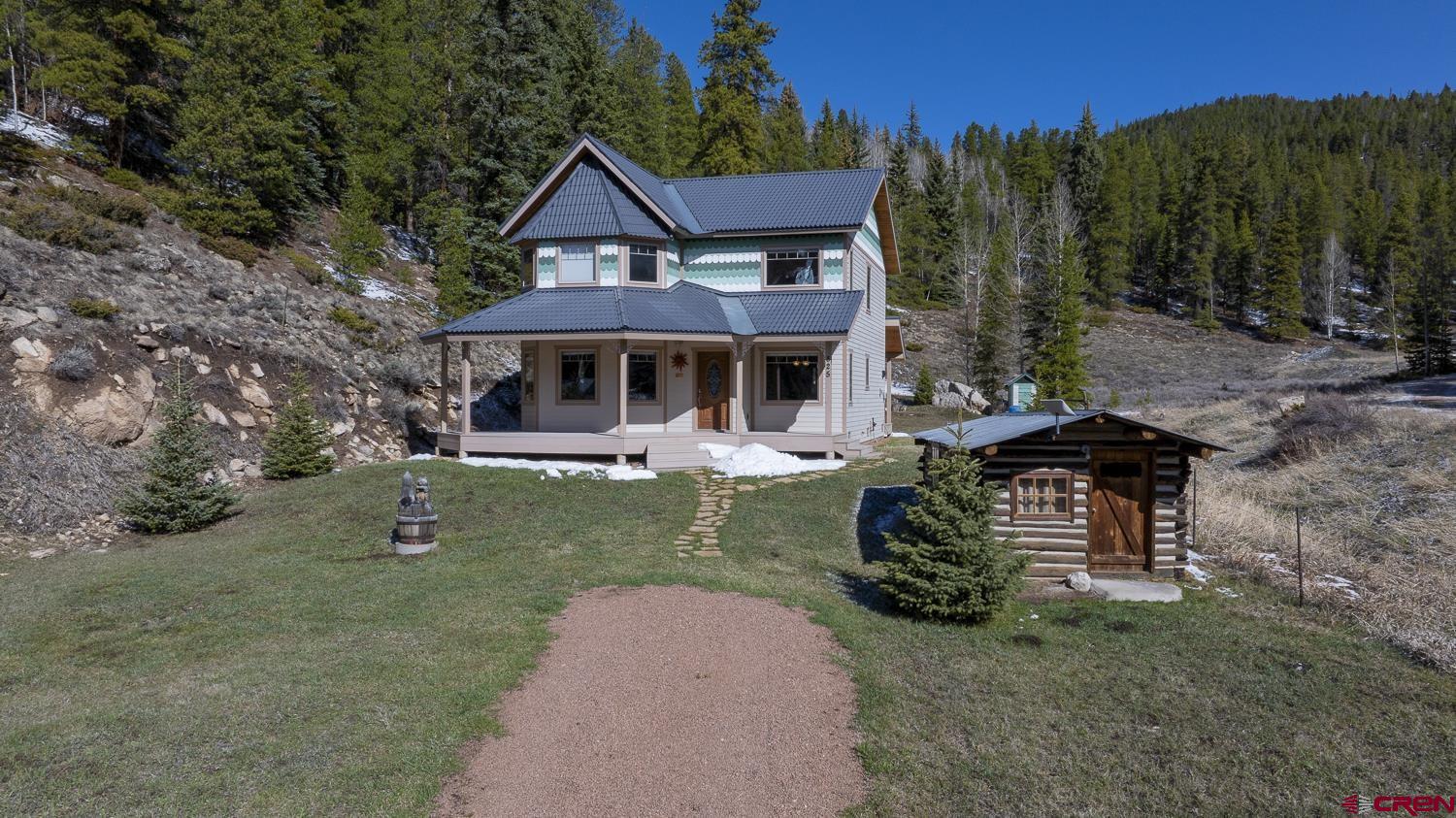 825-823 Main Street Pitkin, CO 81241 - Photo 4 of 42 a front view of a house with garden