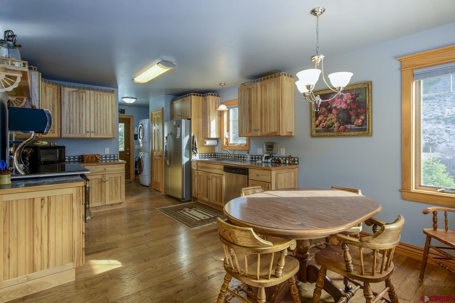 825-823 Main Street Pitkin, CO 81241 - Photo 10 of 42 a kitchen with cabinets and chairs