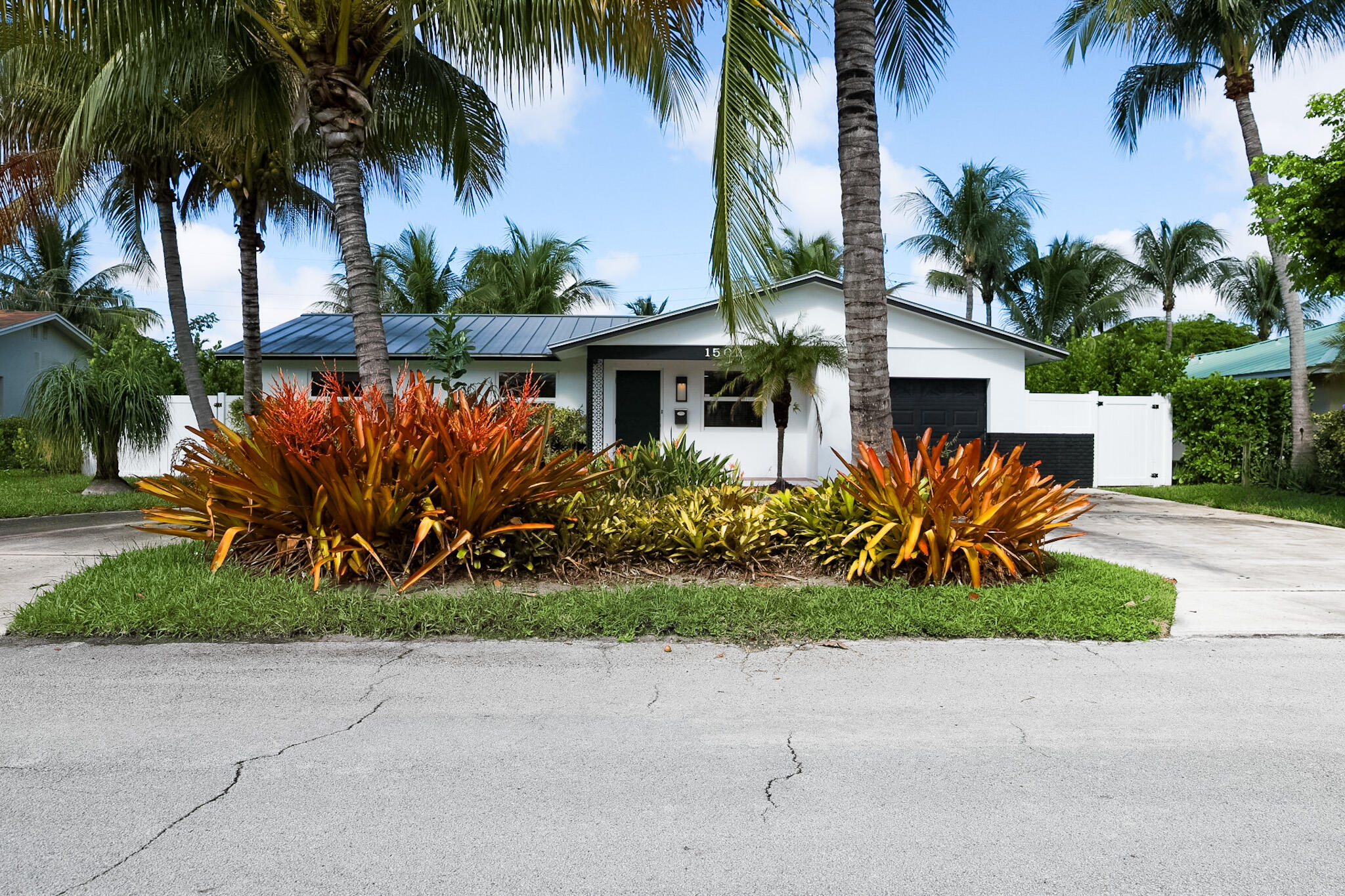 1502 Northwest 4th Avenue Delray Beach, FL 33444 - Photo 1 of 28 a front view of house with small garden and palm trees