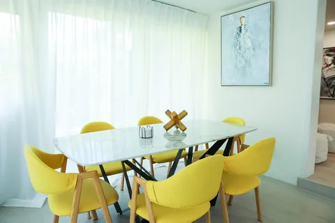 a dining room with chairs and a table