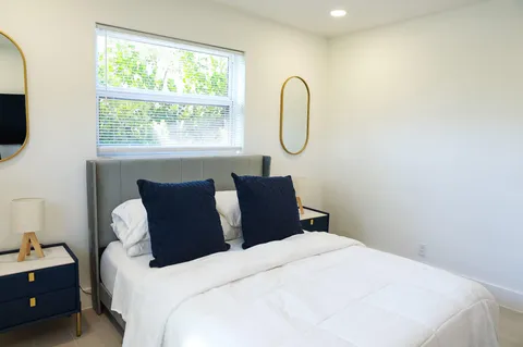 a bed room with a bed a couch and a window