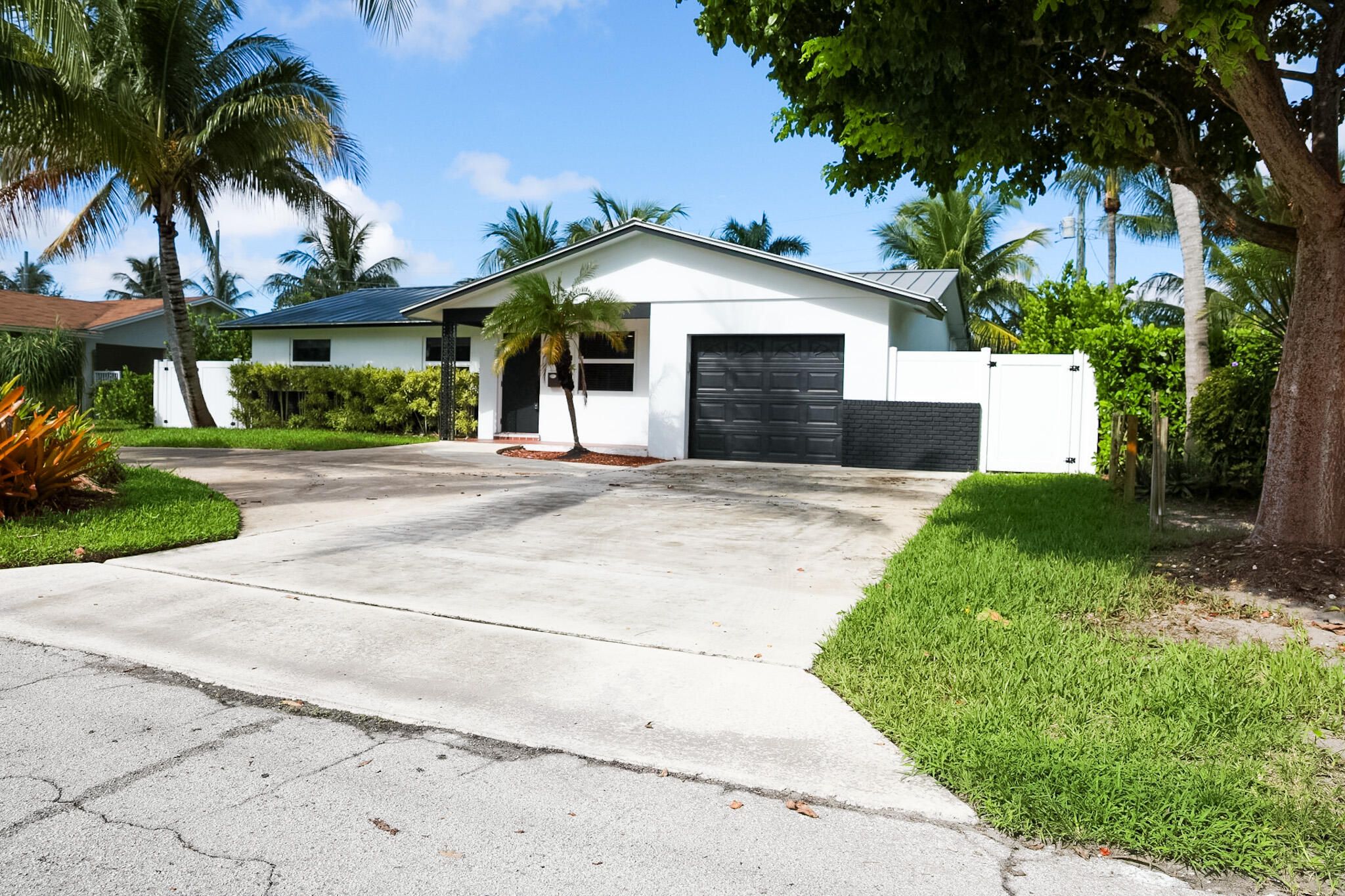 1502 Northwest 4th Avenue Delray Beach, FL 33444 - Photo 3 of 28 a front view of a house with a yard and garage