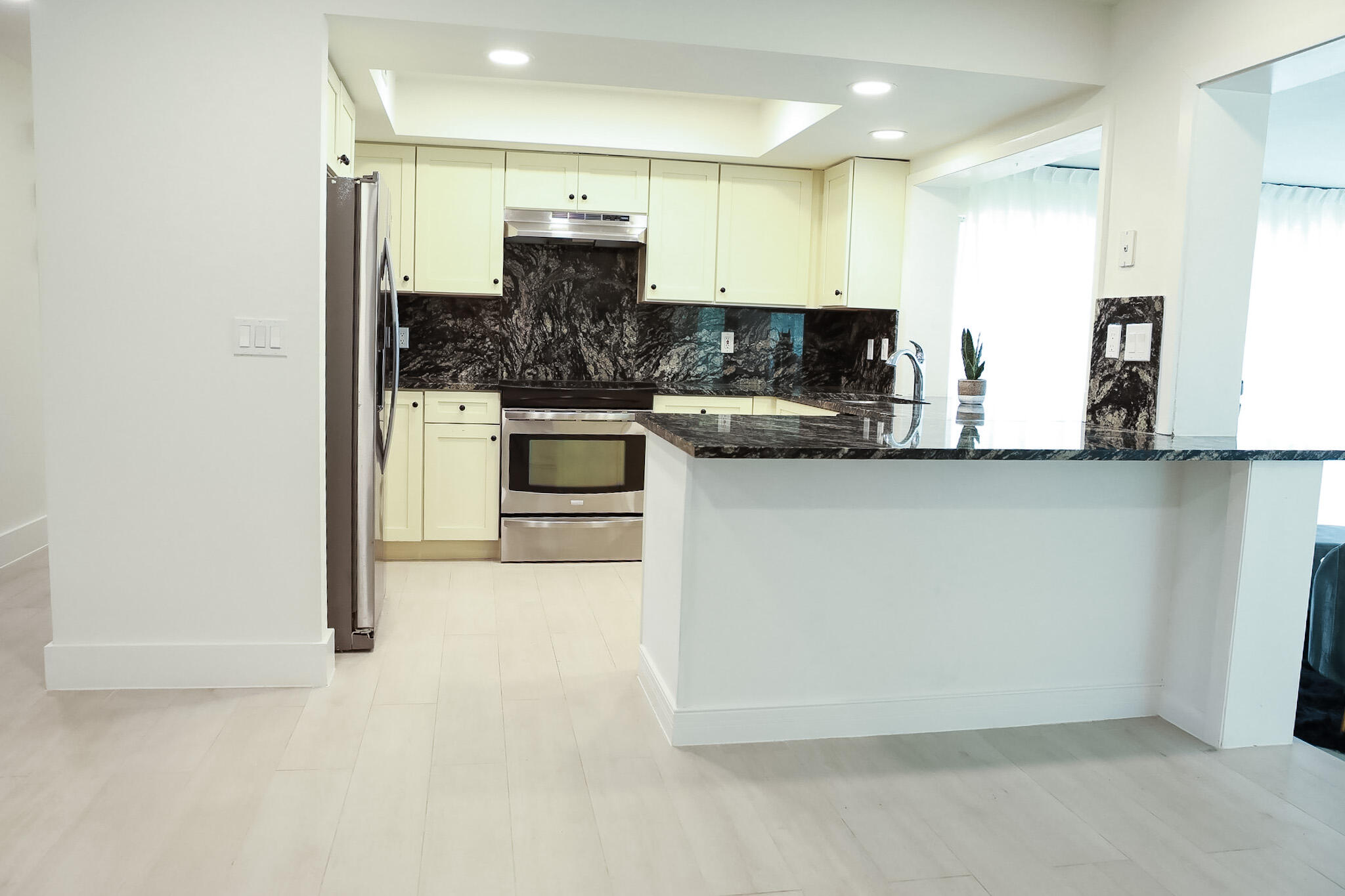 1502 Northwest 4th Avenue Delray Beach, FL 33444 - Photo 9 of 28 a kitchen with stainless steel appliances a refrigerator and a stove top oven
