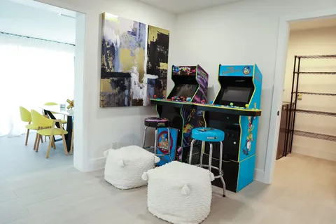 a view of living room with baby crib furniture and two windows