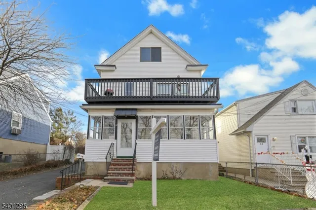 a view of a house with wooden fence