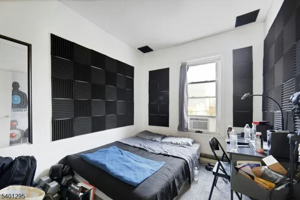 a bedroom with furniture and a window