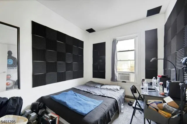 a bedroom with furniture and a window