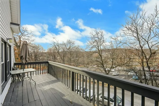 a view of balcony with wooden floor and fence
