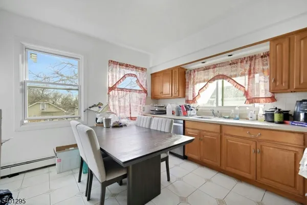 a kitchen with a table chairs sink and cabinets
