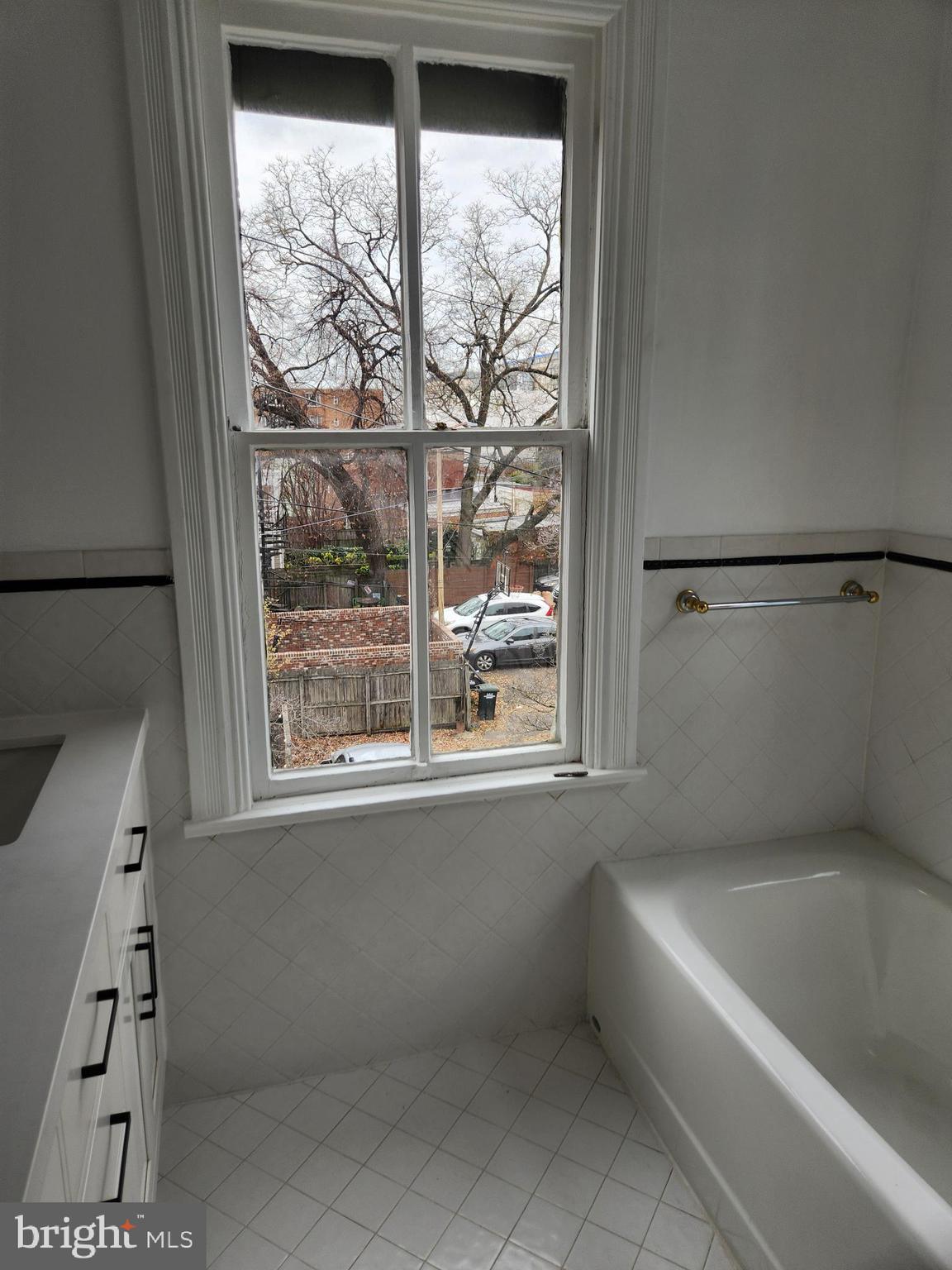 323 2nd Street Southeast Washington, DC 20003 - Photo 13 of 16 a bathroom with a bathtub and a shower