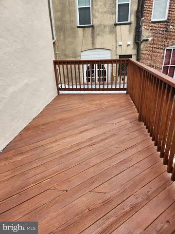 a view of wooden balcony with wooden floor