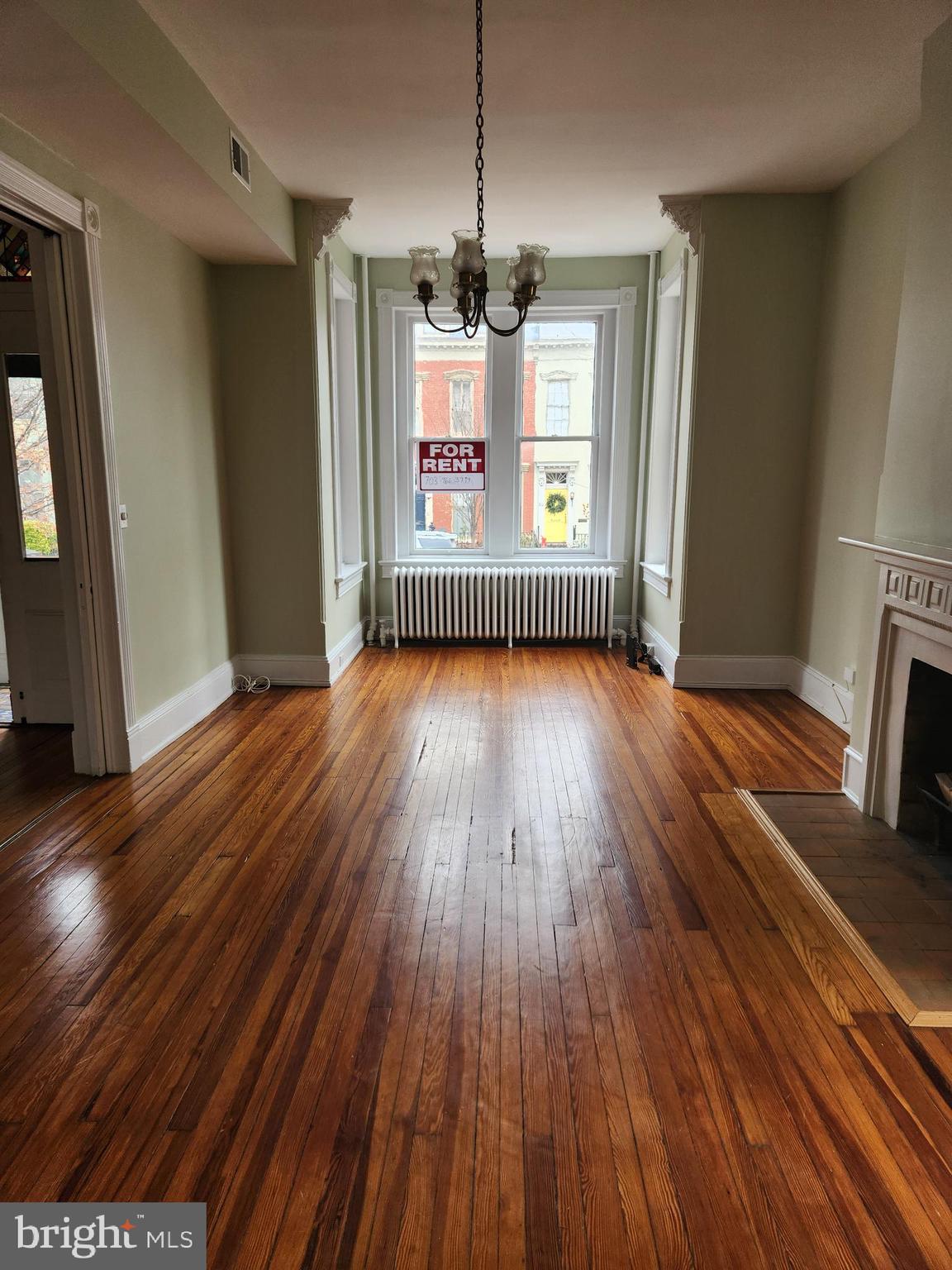 323 2nd Street Southeast Washington, DC 20003 - Photo 3 of 16 a view of an empty room with wooden floor and a window