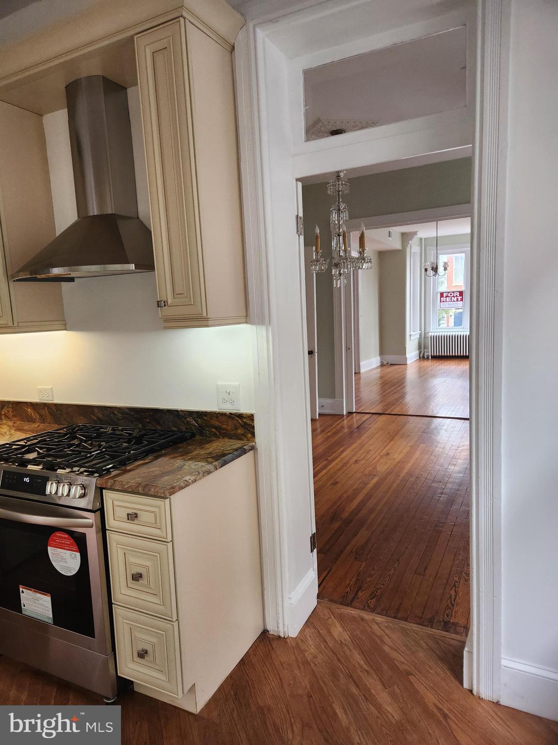 323 2nd Street Southeast Washington, DC 20003 - Photo 5 of 16 a kitchen with granite countertop a stove and a wooden floor