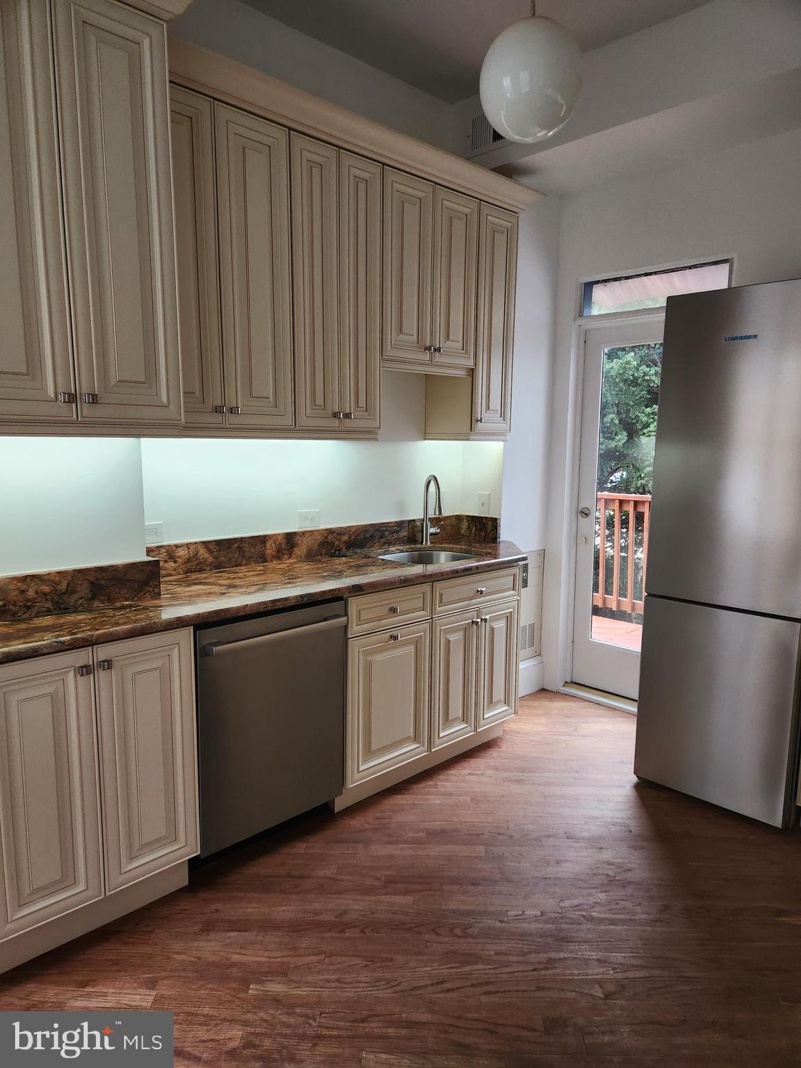 323 2nd Street Southeast Washington, DC 20003 - Photo 6 of 16 a kitchen with granite countertop stainless steel appliances a sink cabinets and a counter top space