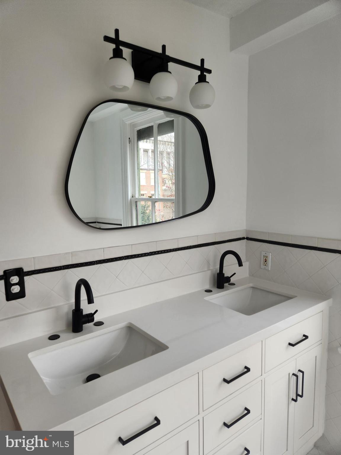 323 2nd Street Southeast Washington, DC 20003 - Photo 9 of 16 a bathroom with a sink and a mirror