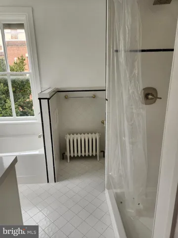 a bathroom with a tub and a shower