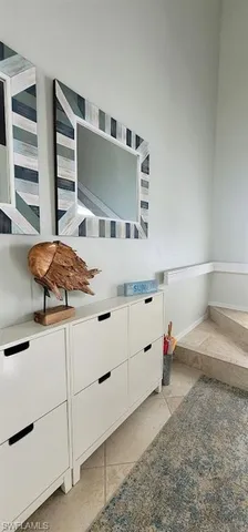 a view of a dining room with furniture a chandelier and wooden floor