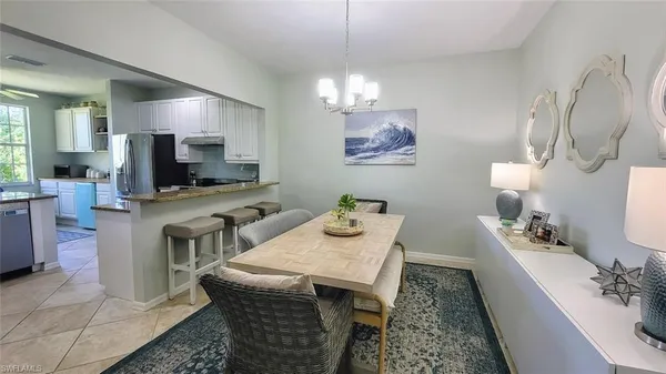 a dining room with furniture and a chandelier