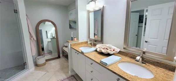 a bathroom with a sink double vanity and a mirror