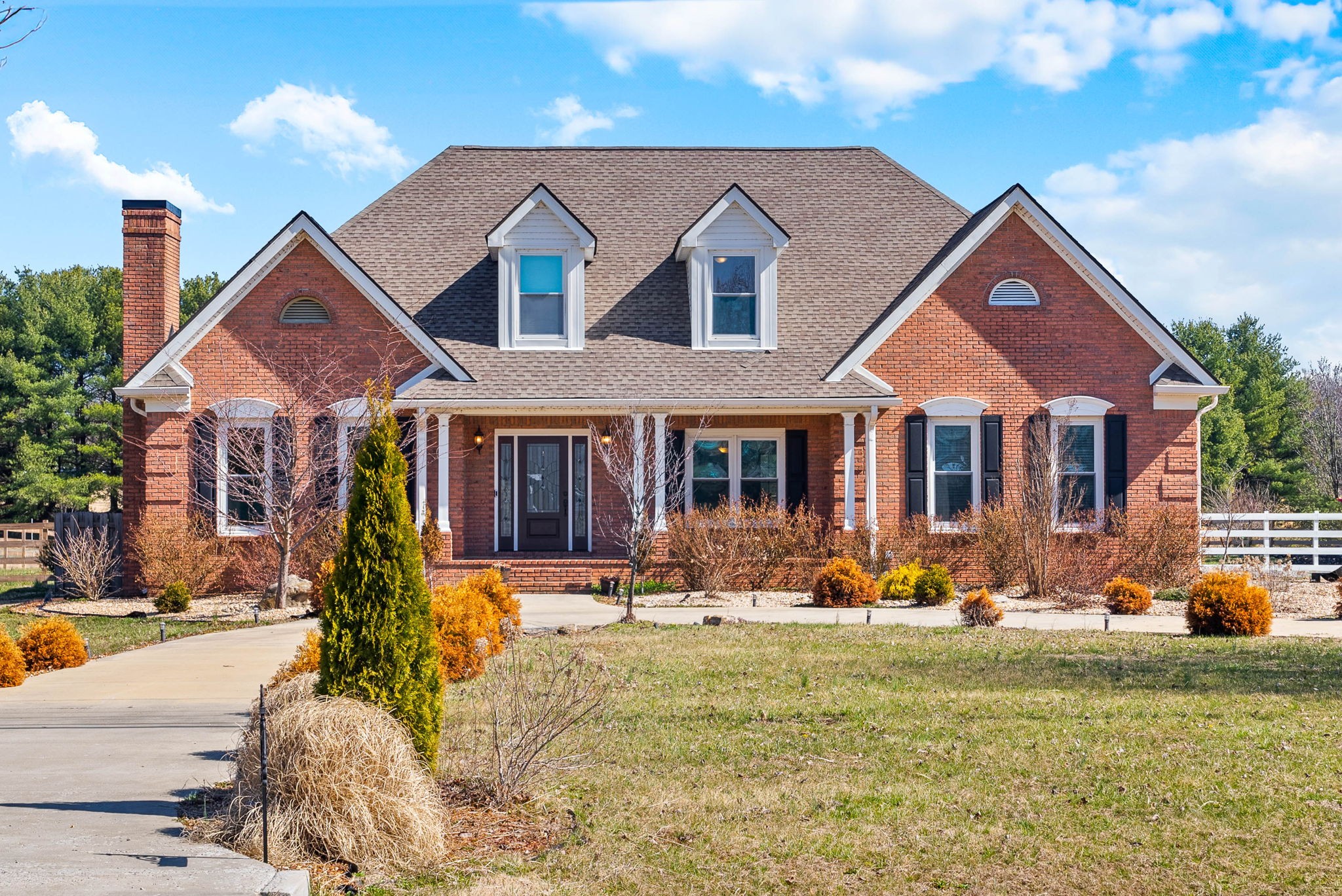 4787 Sango Road Clarksville, TN 37043 - Photo 1 of 55 a front view of a house with yard outdoor seating and covered with trees