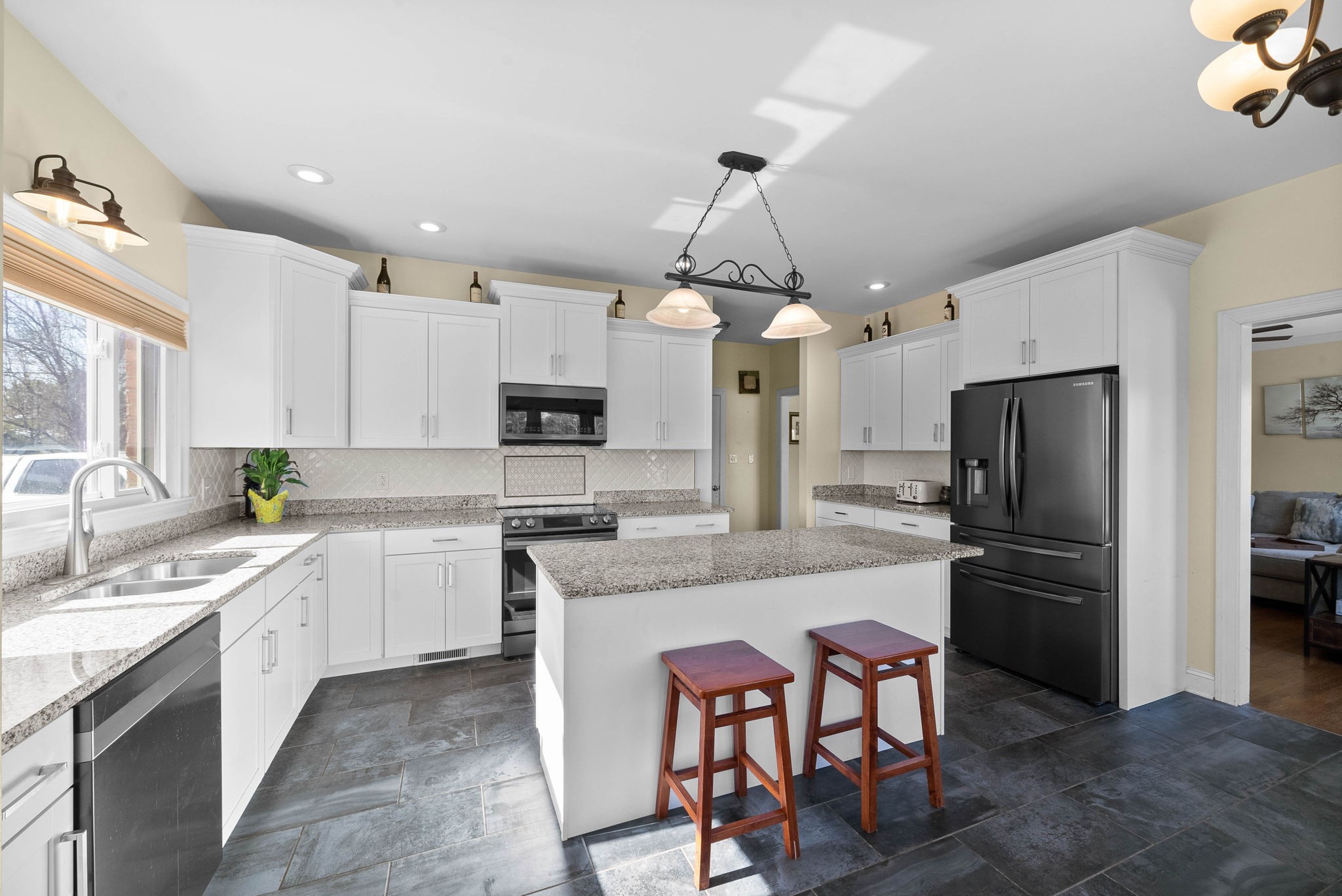 4787 Sango Road Clarksville, TN 37043 - Photo 17 of 55 a kitchen with kitchen island granite countertop a center island a sink stainless steel appliances and cabinets