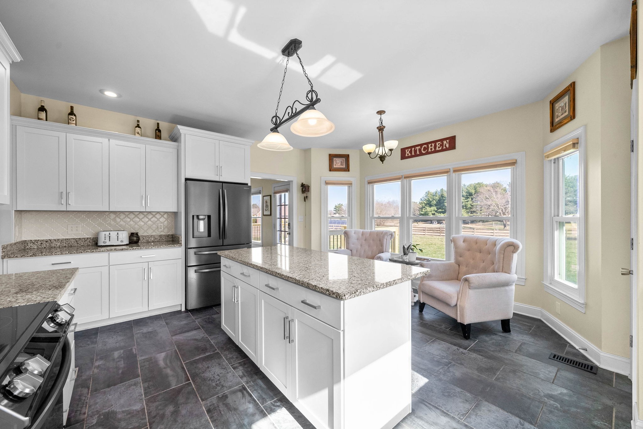 4787 Sango Road Clarksville, TN 37043 - Photo 19 of 55 a large white kitchen with a large window appliances and cabinets